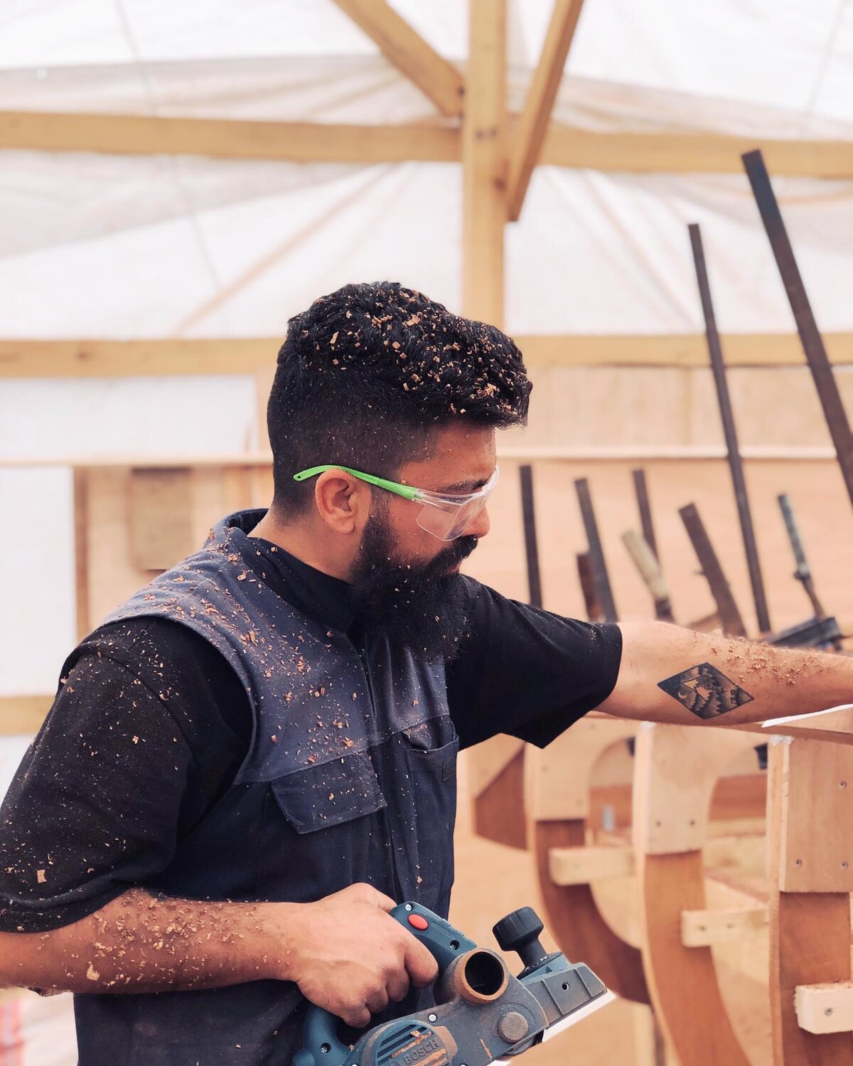 The founder at work, covered in sawdust, in the Frida workshop